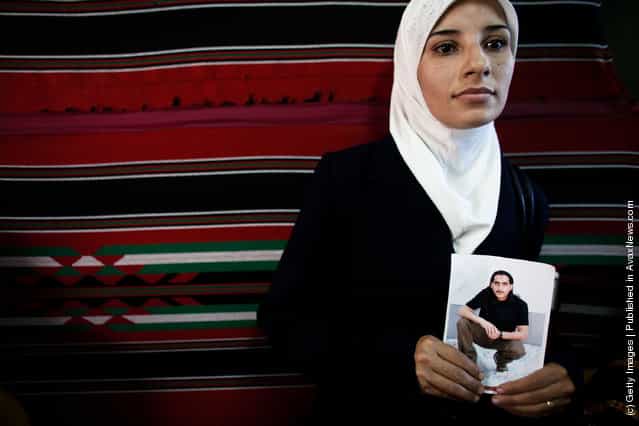 A Palestinian woman holds a picture of a relative jailed in Israel during a protest calling for the release of Palestinian prisoners