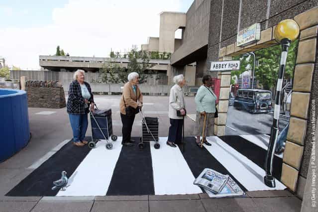 Four elderly women recreate a pose from the front cover of the Beatles Abbey Road album on artwork outside the Hayward Gallery