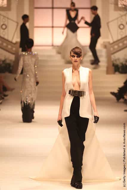 A model showcases designs by Stephane Rolland on the catwalk as part of Women's Fashion Week Haute Couture