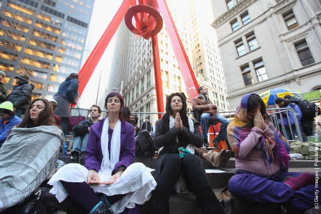 Protesters affiliated with Occupy Wall Street meditate during a flash meditation mob