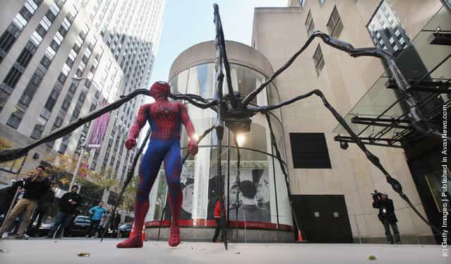Spider-Man: Turn Off the Dark actor Craig Henningsen walks beneath the 21-foot wide Spider sculpture by artist Louise Bourgeois