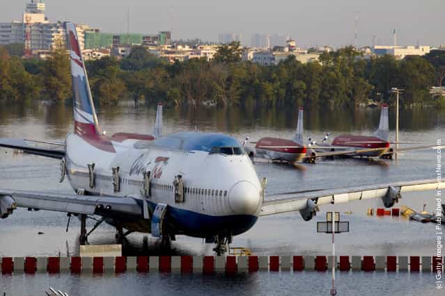 Planes sit on a flooded tarmack of the closed Don Muang airport