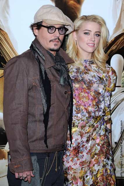 Johnny Depp and Amber Heard pose as they attend the 'Rhum Express' Photocall at Hotel Paris Plaza Athenee