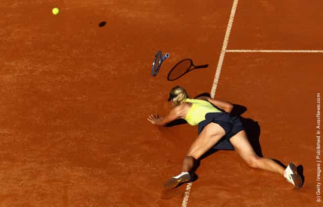 Maria Sharapova of Russia falls during her semi final match against Caroline Wozniacki of Denmark