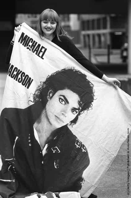 A Michael Jackson fan with a large poster of her idol on April 14, 1988