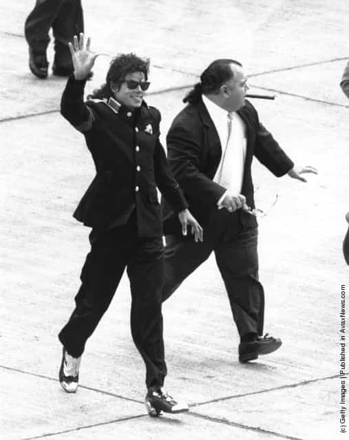 American singer Michael Jackson (1958 - 2009) arrives at Heathrow Airport with his manager Frank DiLeo, on his Bad World Tour, 11th July 1988