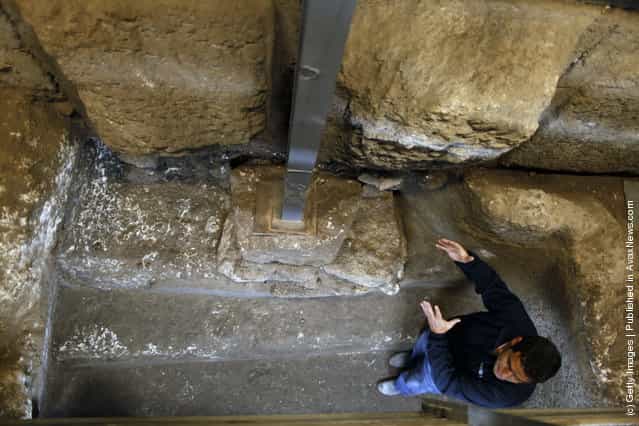Israeli Archaeologist Eli Shukron of the Israel Antiquities Authority speaks inside a ritual bath exposed beneath the Western Wall in Jerusalems Old City, Israel