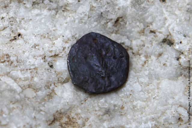 One of the two ancient bronze coins, which according to Israel Antiquities Authority archaeologists were struck by the Roman procurator of Judea, Valerius Gratus