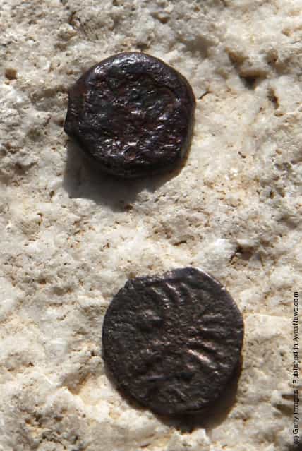 Two ancient bronze coins, which according to Israel Antiquities Authority archaeologists were struck by the Roman procurator of Judea, Valerius Gratus, in the year 17/18 CE and recently were revealed in excavations beneath the Western Wall in Jerusalems Old City