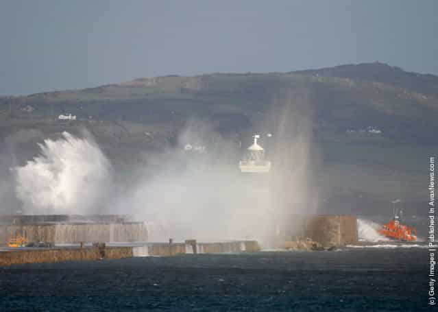 A lifeboat passes by the Holyhead breakwater as the search continues for the crew of cargo vessel The Swanland, which sank off north Wales on November 27, 2011 in Holyhead, Wales