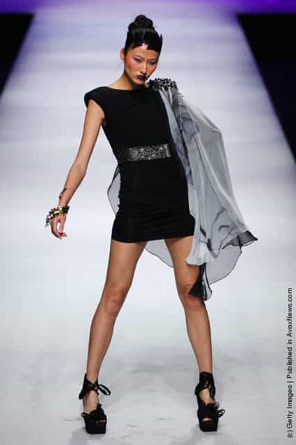 A model walks the runway during SCFASHION Qi Gang 2011 S/S Collection at China Fashion Week