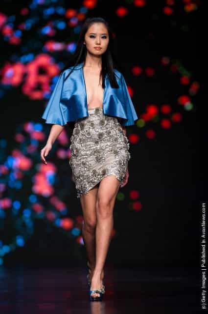 A model showcases outfits by Lebanese designers Modessa Couture during their 'Fleur the chine Par' show on the second day of Hong Kong Fashion Week