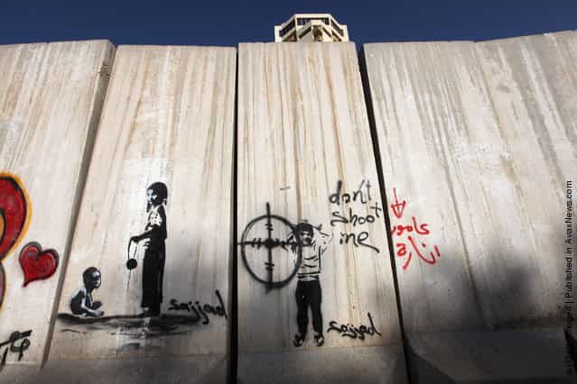 Graffiti is seen on a protective blast wall in Baghdad, Iraq