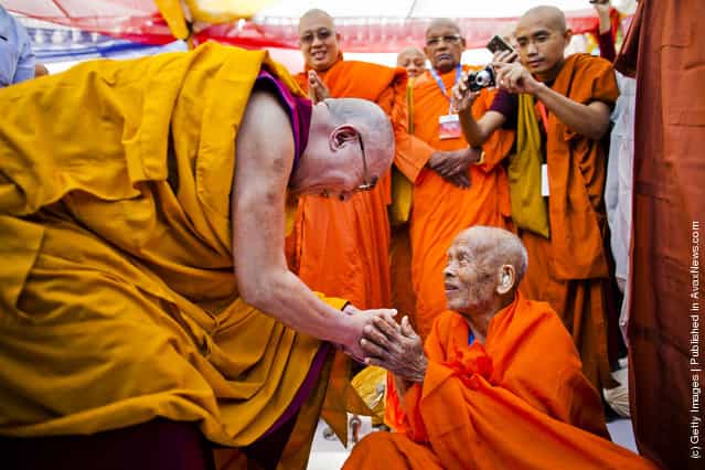 His Holiness, the Dalai Lama greets an elderly Buddhist monk at a multi-faith prayer gathering at Gandhi Smriti prior to his keynote speech at the Global Buddhist Congregation on November 30, 2011 in New Delhi, India. The Dalai Lama is attending the four day Global Buddhist Congregation, which will be attended by religious leaders from 32 countries. The aim of the Congregation is to set up an international forum that will aim to promote global peace, stability and prosperity through collective action, while rejecting prejudices, exploitation and violence