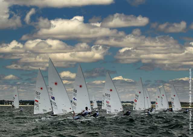 The Laser Men's One Person Dinghy fleet round a mark on the Parmeila Course