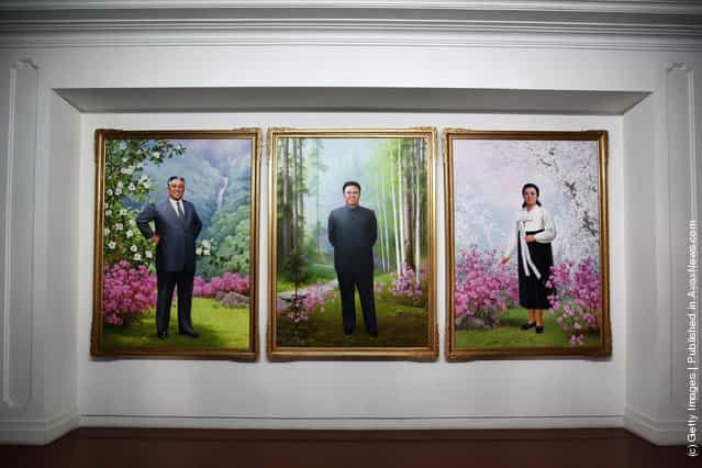 Portrait painting of Kim Il Sung (Left) and Kim Jong Il (Center) are seen inside a government building