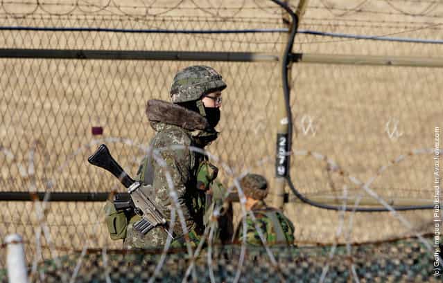 South Korean soldiers patrol inside the barbed-wire fence at Imjinkak, near the Demilitarized zone (DMZ) separating South and North Korea
