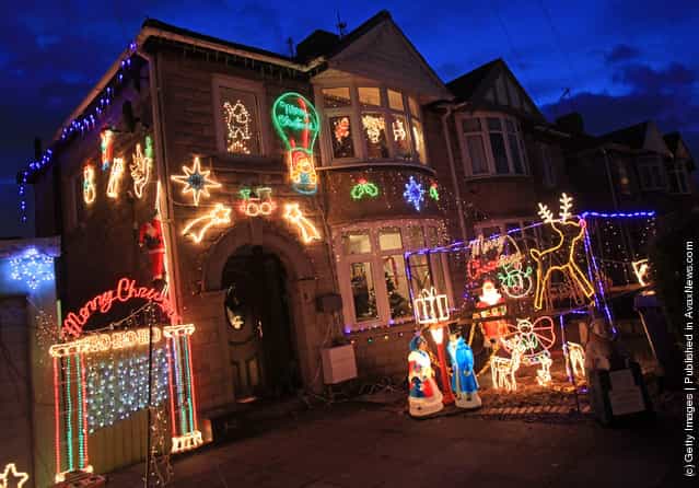 A semi-detached house is lit up with exterior Christmas lights
