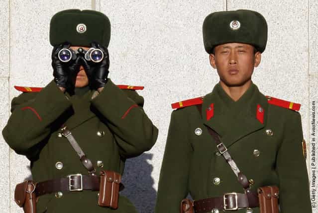 North Korean soldiers look at South Korea across the Korean Demilitarized Zone (DMZ)