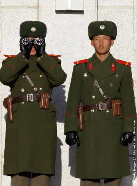 North Korean soldiers look at South Korea across the Korean Demilitarized Zone (DMZ)