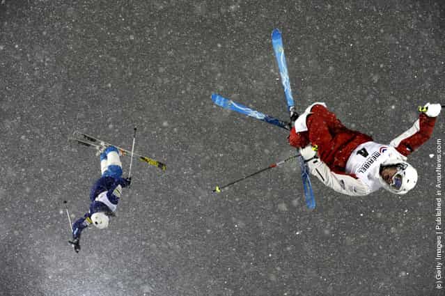 Denis Dolgodorov of Russia and Mikael Kingsbury of Canada compete during the FIS Freestyle Ski World Cup Dual Moguls