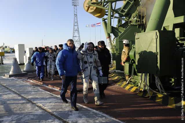 ESA Russian cosmonaut Oleg Kononenko, NASA astronaut Don Pettit and ESA astronaut Andre Kuipers wave goodbye to the crowd gathered at the foot of the Soyuz launch pad stairs before taking the elevator to the top of the Soyuz rocket