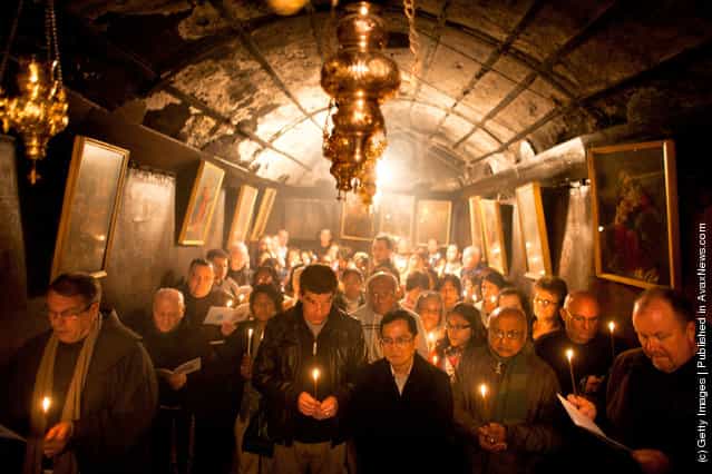Christian pilgrims pray at the Grotto in the Church of the Nativity in Bethlehem, West Bank