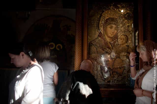 Women pray in the Church of the Nativity