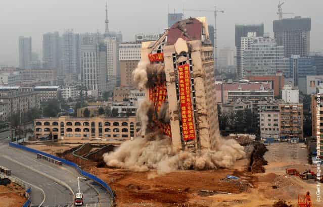 An old 80 metre high office building of Kunming municipal government is demolished in directional blasting in Kunming, Yunnan Province of China
