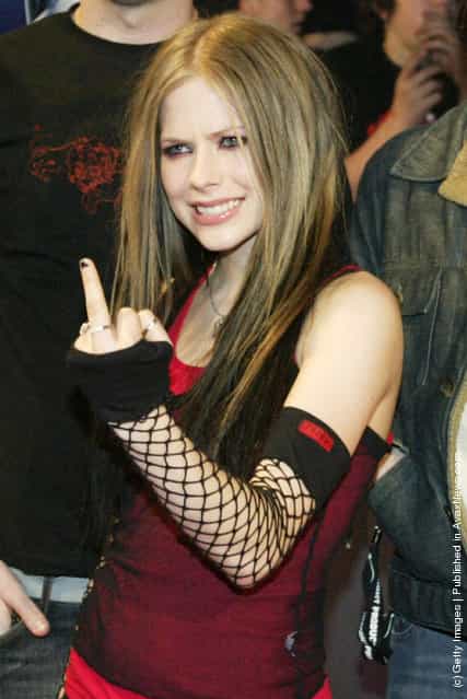 Musician Avril Lavigne gestures as she arrives for the JUNO Awards ceremony at the Rexall Centre