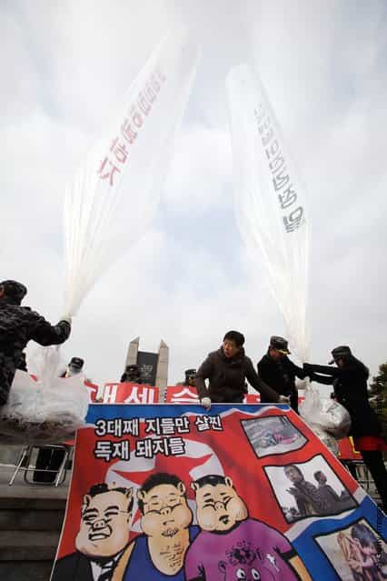 North Korean defectors, now living in South Korea, prepare to release balloons carrying propaganda leaflets denouncing North Koreas late leader Kim Jong-Il at Imjingak, near the Demilitarized zone