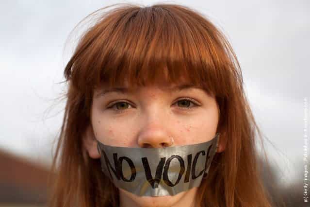 Frankie Hughes, 14, a protestor affiliated with the Occupy Wall Street movement, demonstrates outside the Iowa Democratic Party headquarters