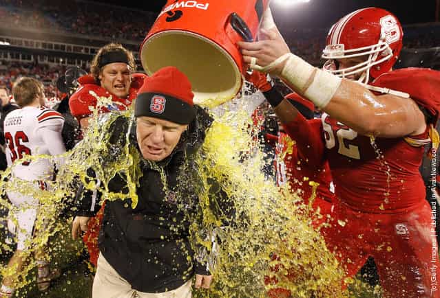 Head coach Tom O'Brien of the North Carolina State Wolfpack is dunked in Gatorade after defeating the Louisville Cardinals 31-24 at Bank of America Stadium