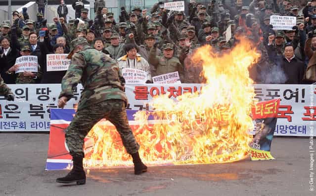 Protesters burn the North Korean flag during a rally at Seoul Station on December 28, 2011 in Seoul, South Korea