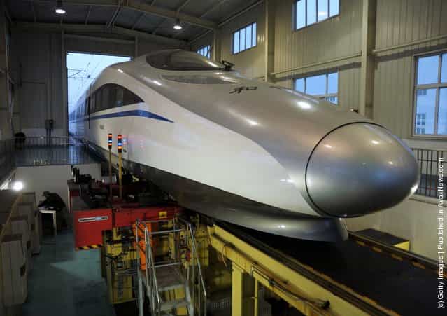 Technicians check a CRH high-speed train at Shanghai Hongqiao High-speed train base