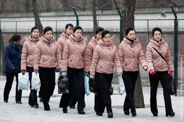North Korean people arrive at the North Korea Embassy to mourn the death of North Korean leader Kim Jong-il