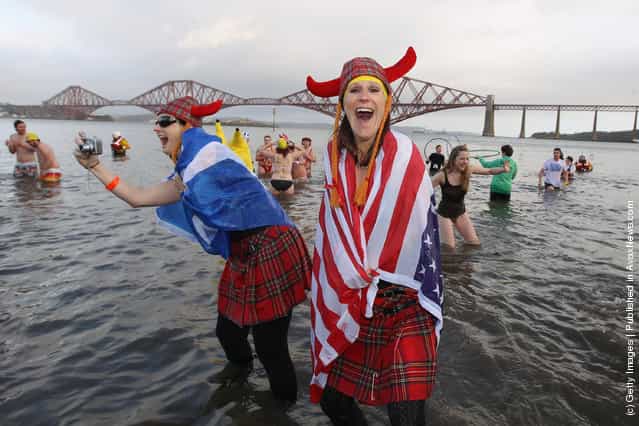 New Year revellers, many in fancy dress, braved freezing conditions in the River Forth in front of the Forth Rail Bridge during the annual Loony Dook Swim