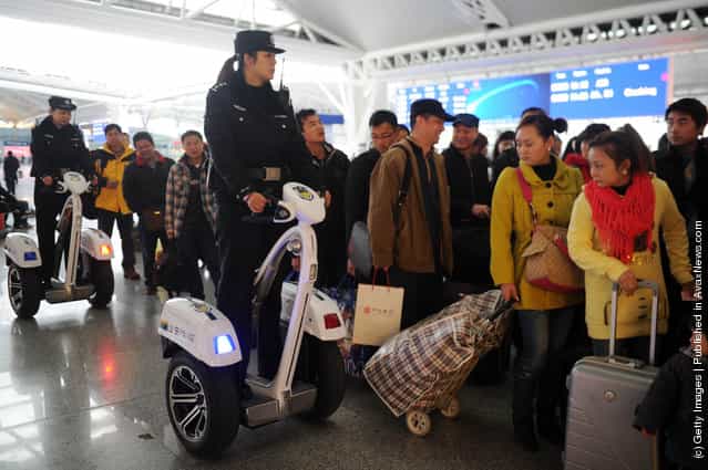 Police women ride Segways as they patrol at Guangzhou South Railway Station in Guangzhou, China
