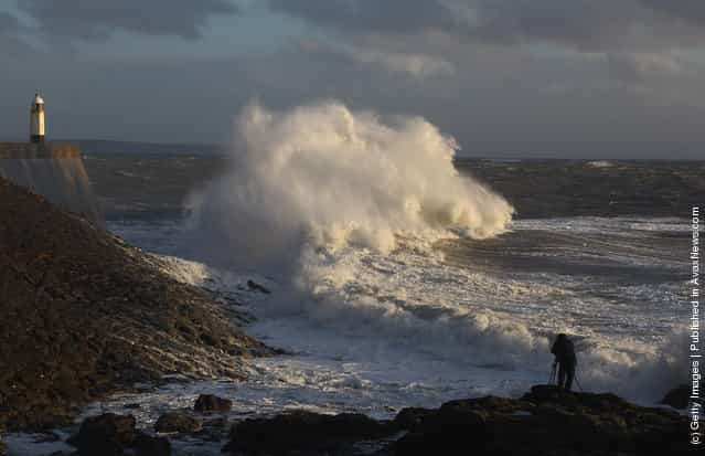 Waves crashing against the harbour wall in Porthcawl, Wales