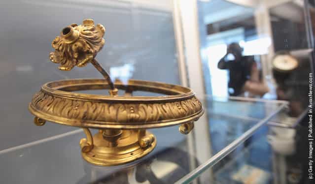 Part of a gold chandelier is seen among artifacts recovered from the RMS Titanic