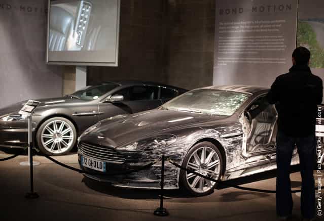 A man looks at the two Aston Martin DBS that were used in the James Bond film Quantum Of Solace and currently being displayed at the Bond In Motion exhibition