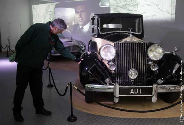 A member of the musuem team attends to a Rolls-Royce Phantom III used in the James Bond film Goldfinger