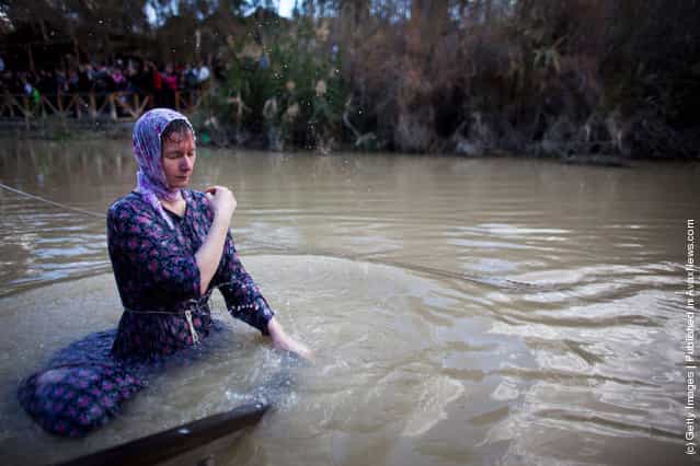 Orthodox Christian pilgrims are baptized during Epiphany celebrations in the Jordan River