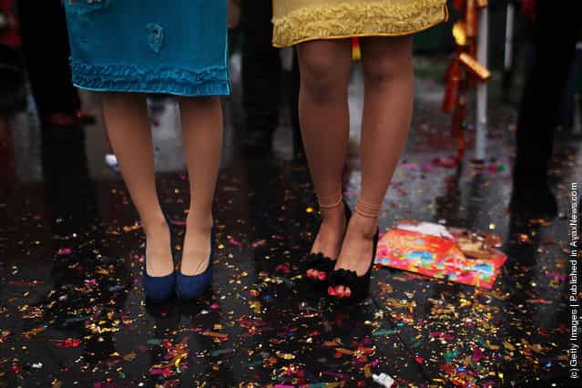 Two Chinese singers stand on glitter during celebrations of the Chinese New Year in Chinatown
