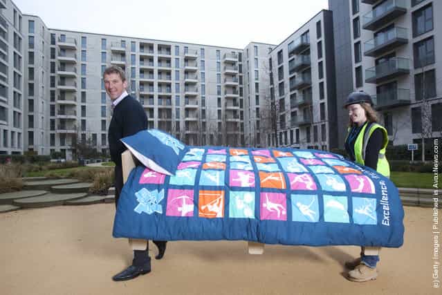 Olympian Matthew Pinsent helps lift in the first of 16,000 beds to be installed in Village as the ODA completes construction of apartments on time and LOCOG begins Games-time fit-out of Village