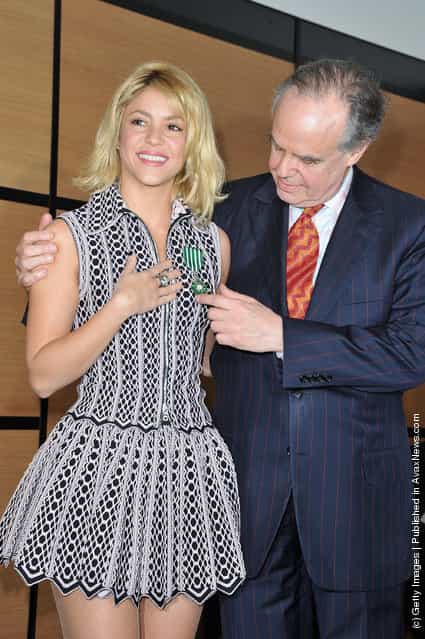 Shakira poses with French Culture Minister, Frederic Mitterrand after being honored at Hotel Majestic