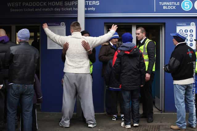 Football fans are searched before entering the Loftus Road stadium