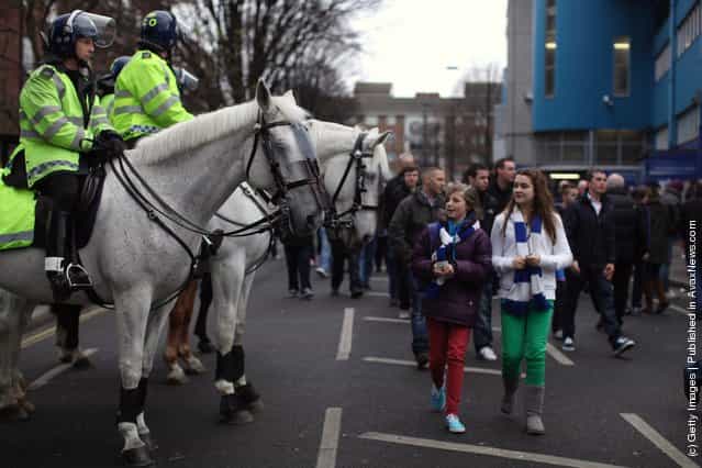 Fans makes their way into the Loftus Road stadium for the FA Cup Fourth Round between Queens Park Rangers and Chelsea