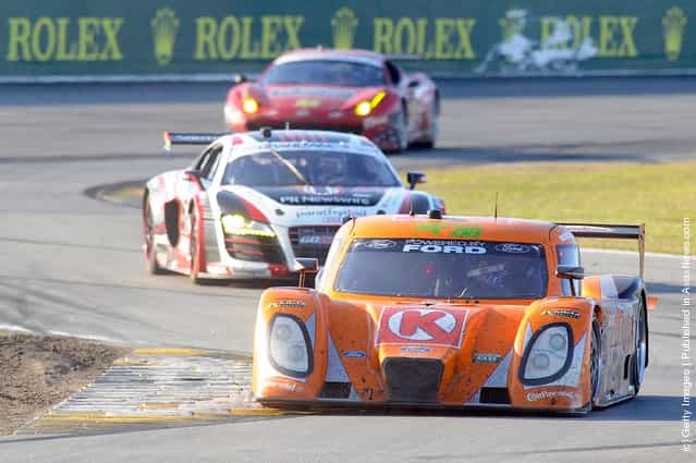 The #77 DP Ford Dallara driven by Brian Fisselle, Burt Frisselle, Jim Lowe and Paul Tracy race into a turn during the Rolex 24