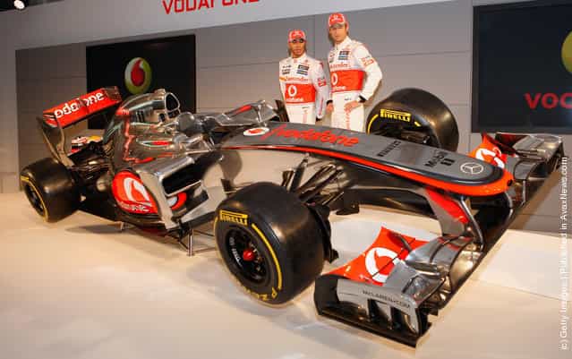Team McLaren Mercedes drivers Lewis Hamilton (L) and Jenson Button unveil the new MP-27 Formula 1 car at the McLaren technology centre